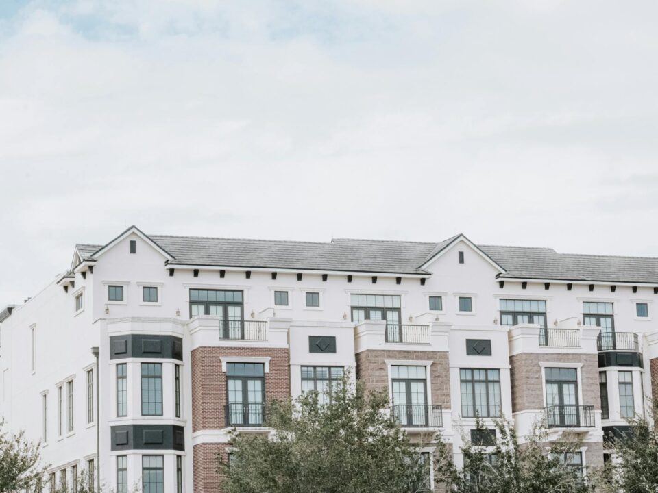 Exterior view of modern Northridge Apartments with landscaped garden and parking area.
