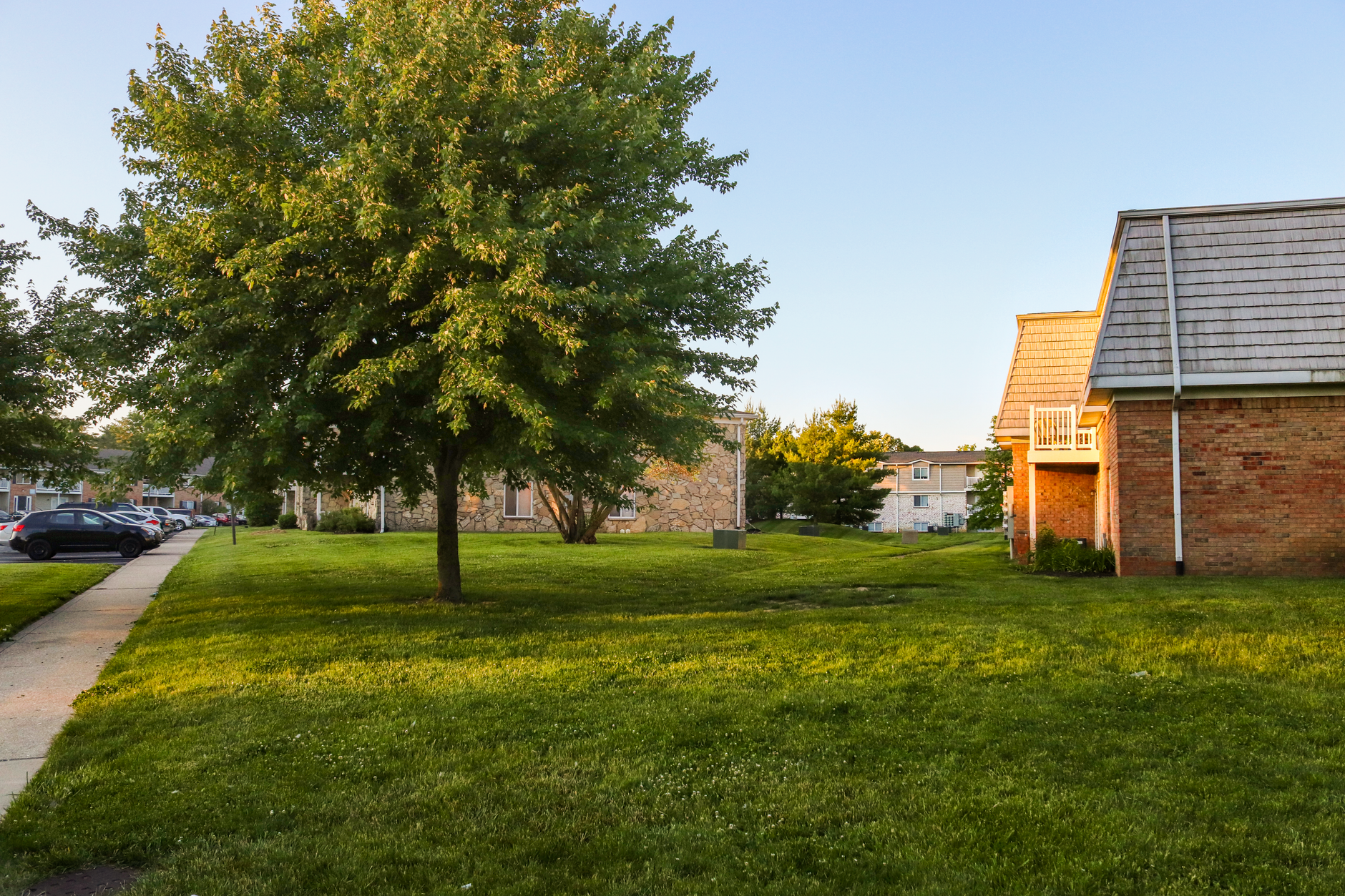 Exterior view of Maple Ridge Apartments with modern architecture and landscaped garden