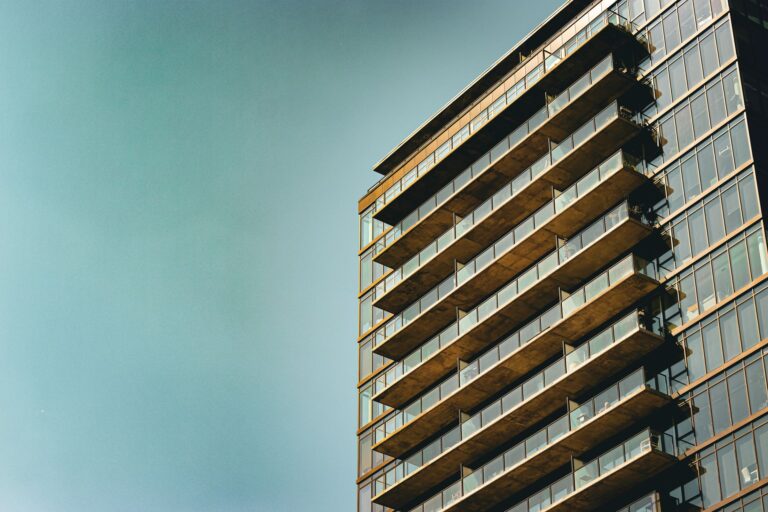 Menara tinggi menampilkan studio apartemen modern dengan jendela panoramik, cocok untuk hunian urban bergaya minimalis