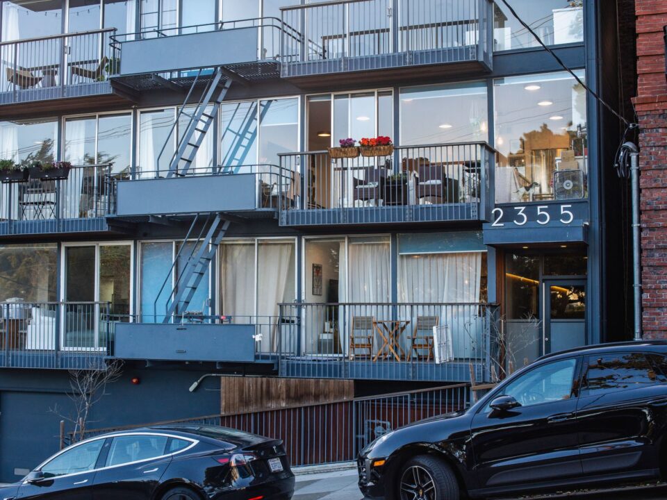Exterior modern Hana Apartments with sleek glass facade and landscaped garden, ideal urban living.