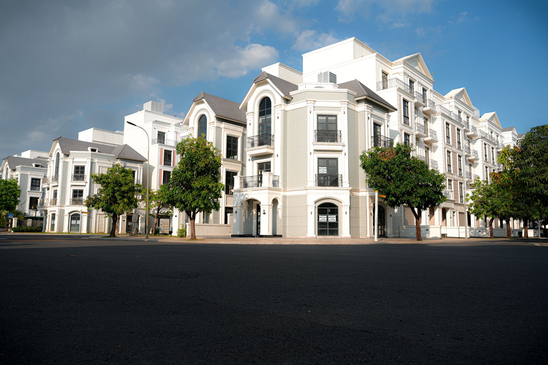 Exterior view of Hyde Park Luxury Apartments with glass facade and garden, highlighting premium urban living.